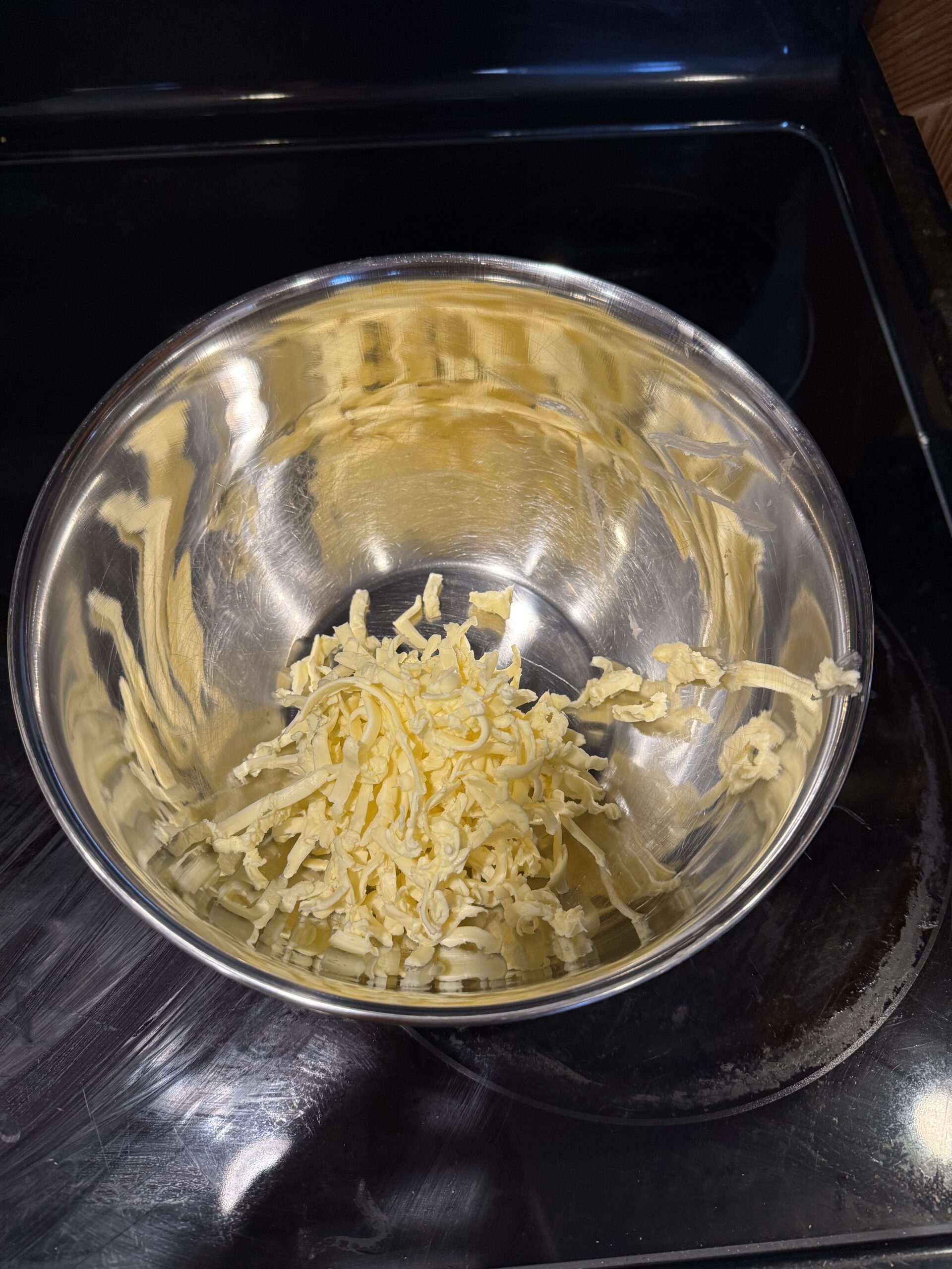 1. Shred cold butter (or margarine) into bowl.